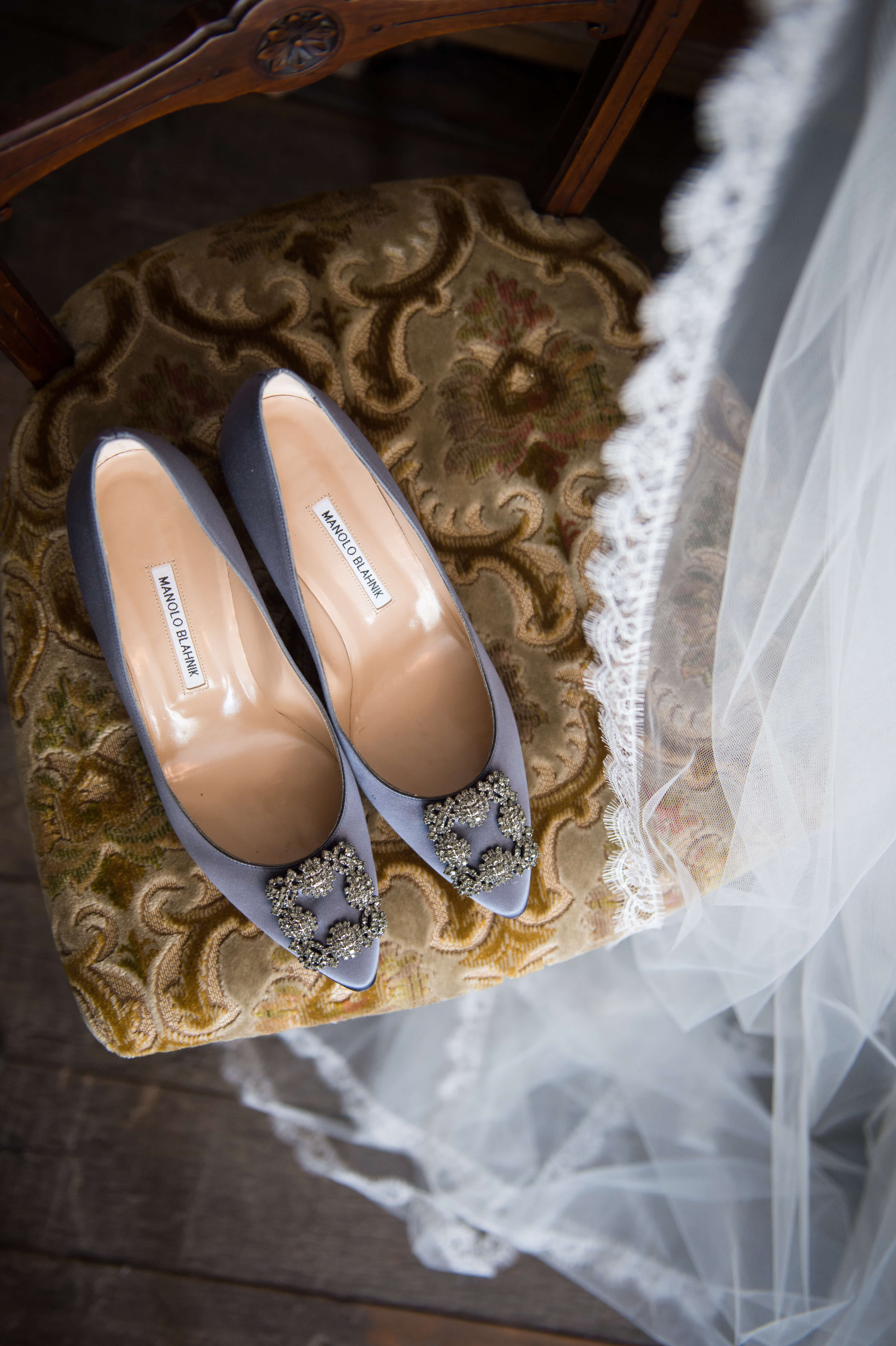 manolo blahnik wedding shoes and veil on a chair